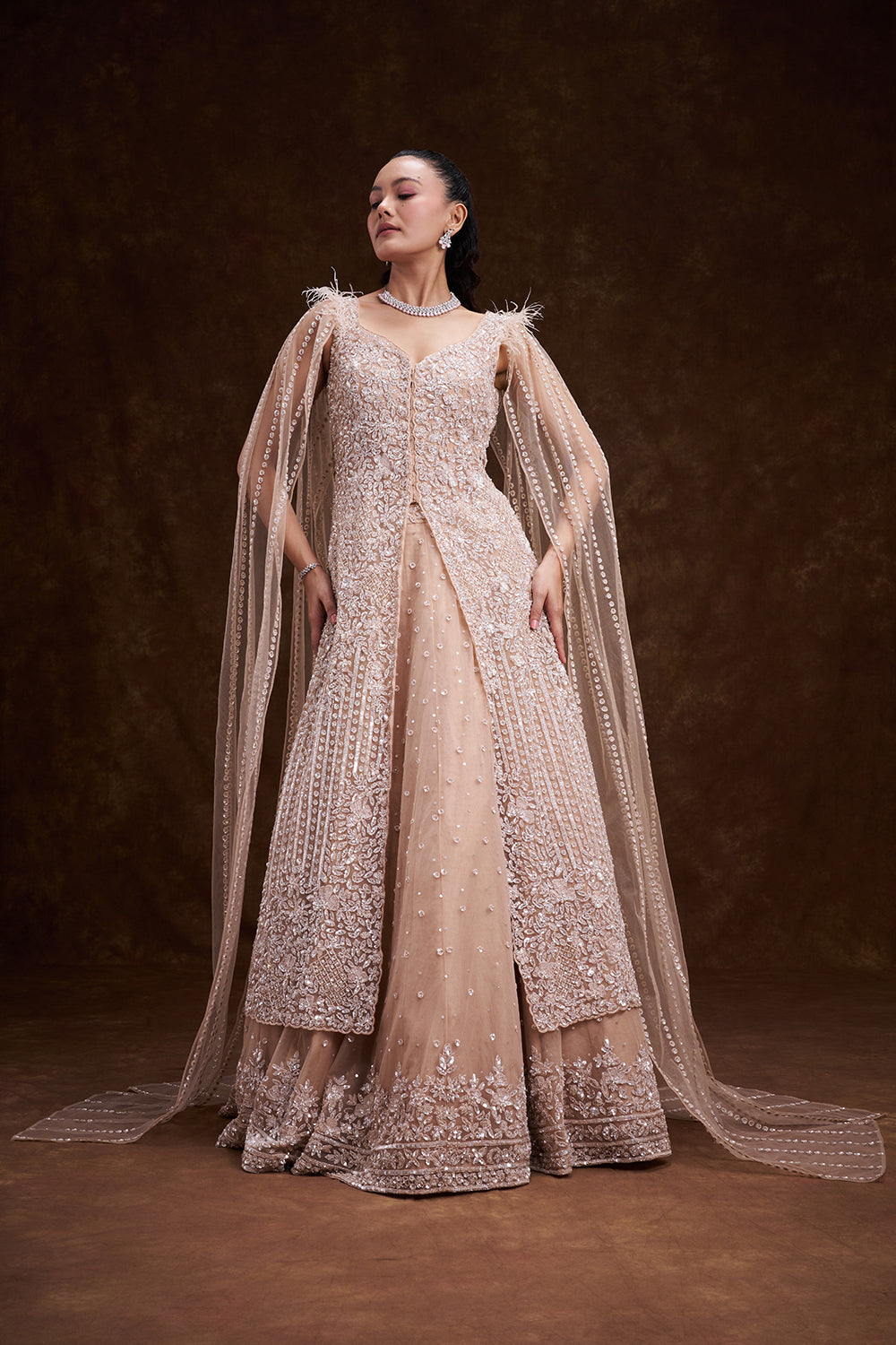 Beige Golden Net Bridal Lehenga with Feathered Cape Detail