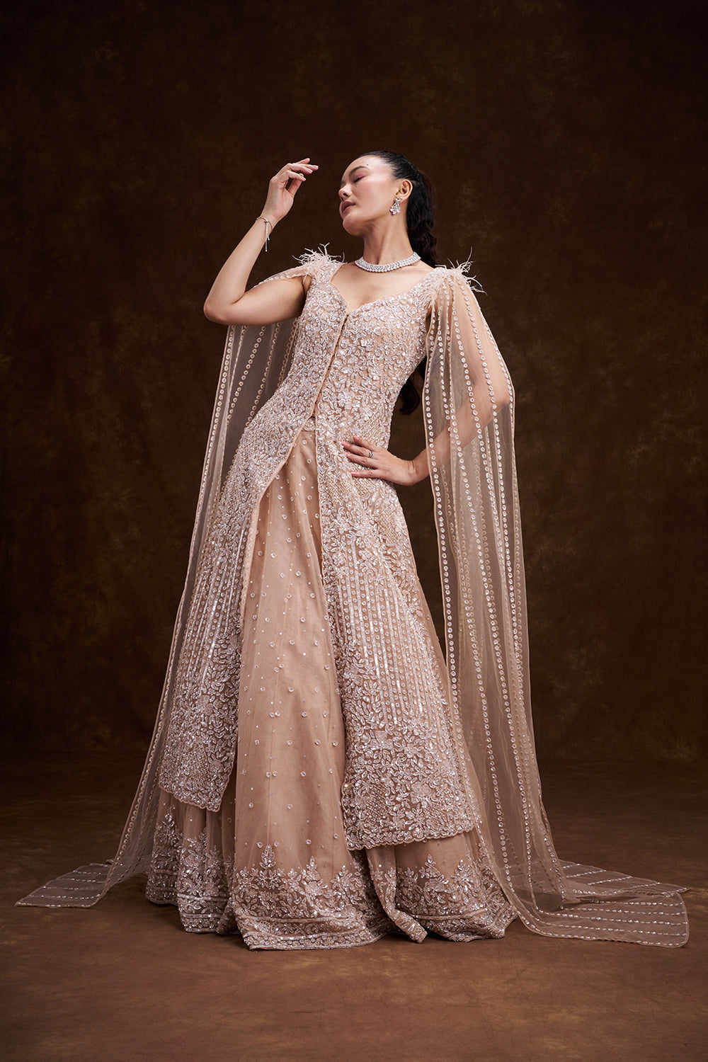Beige Golden Net Bridal Lehenga with Feathered Cape Detail