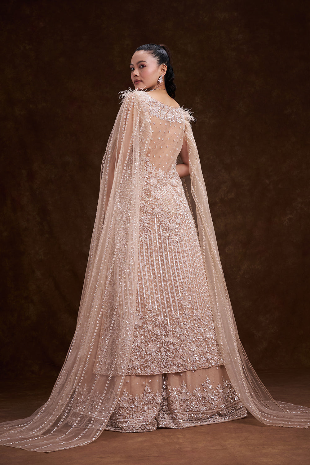 Beige Golden Net Bridal Lehenga with Feathered Cape Detail